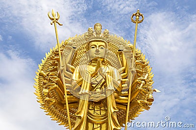 Golden quan yin thousand hands statue Stock Photo