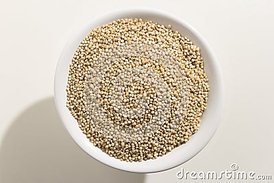 Golden Quinoa seed. Top view of grains in a bowl. White background. Stock Photo