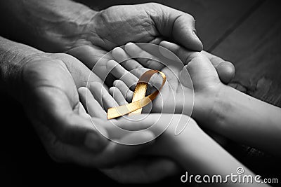 Golden ribbon childhood symbol of the fight against cancer.black and white. Stock Photo