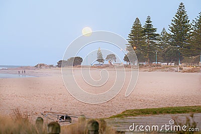 Golden rising moon over Mount Maunganui Main Beach Stock Photo