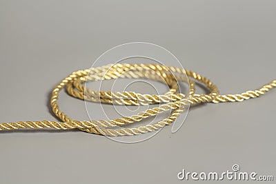 Golden rope on gray Stock Photo