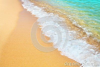 Golden sand beach, blue sea wave and white foam landscape, turquoise transparent ocean water splash, summer holidays concept Stock Photo