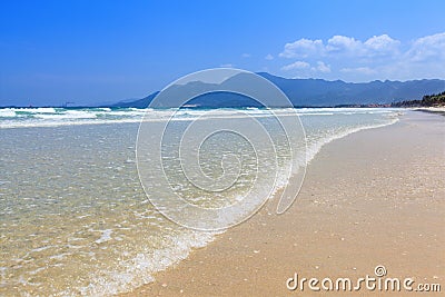 Golden sand and wave beach blue sky daylight landscape Stock Photo