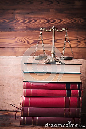 Golden scale on top of stack of law books Stock Photo