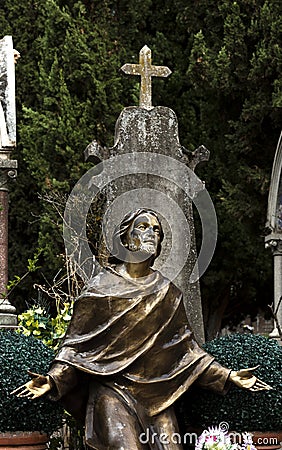 Golden sculpture praying under the cross Stock Photo