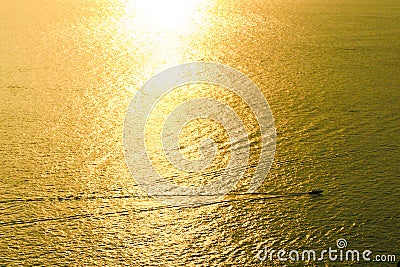 Golden sea with moving boat Stock Photo