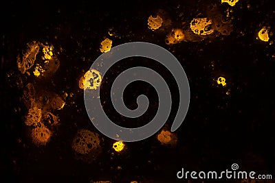 Golden shiny bokeh lights on dark background. Yellow glittering blurred texture. Lights and bubbles abstract defocused background Stock Photo