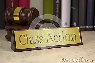 Golden sign with engraved word class action - sammelklage on a desk with gavel Stock Photo