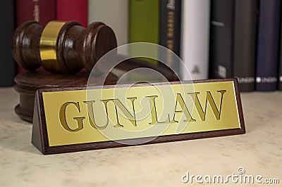 Golden sign with gavel and gun law Stock Photo