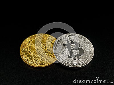 Golden and silver bitcoin on black background. Bitcoin cryptocurrency. Stock Photo