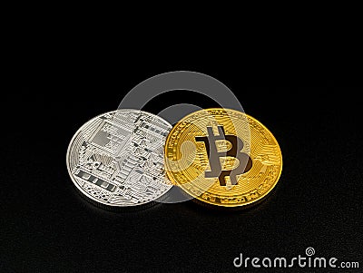 Golden and silver bitcoin on black background. Bitcoin cryptocurrency. Stock Photo