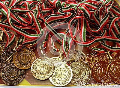 Golden, silver, bronze sports medal with red, white and green ribbon. Winner awards Stock Photo