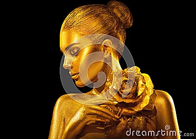 Golden skin woman with rose. Fashion art portrait. Model girl with holiday golden glamour shiny professional makeup Stock Photo