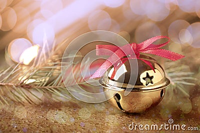 Golden sleigh bells and fir branches on table, closeup Stock Photo