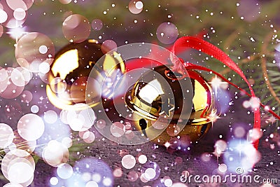 Golden sleigh bells and fir branches on table, closeup. Bokeh effect Stock Photo