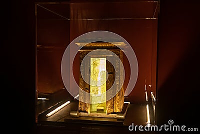 Replica golden small egyptian shrine indoors inside exhibition dark and no people archaeology religion Editorial Stock Photo