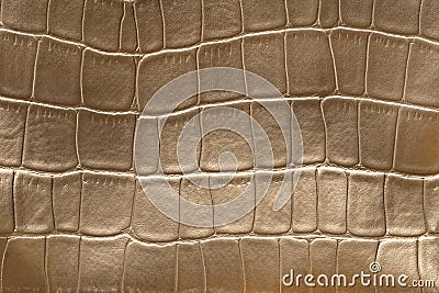 Golden snake skin pattern imitation made of faux leather. Crocodile skin surface texture made from artificial leather Stock Photo