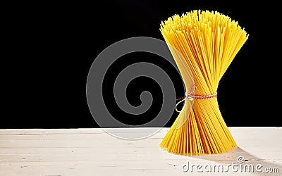 Bunched spaghetti on table with black copy space Stock Photo