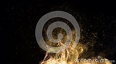 Golden sparks, gold powder, dust, magic Christmas and New Year glittering stars swirl on black background Stock Photo