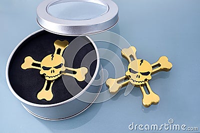 Golden spinner in the form of a skull Stock Photo