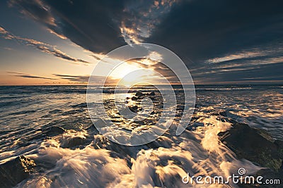 Golden splashing waves and sunrise sea Stock Photo