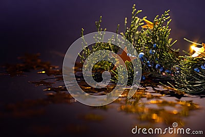 Golden stars on a spruce twig Christmas decorations. Stock Photo