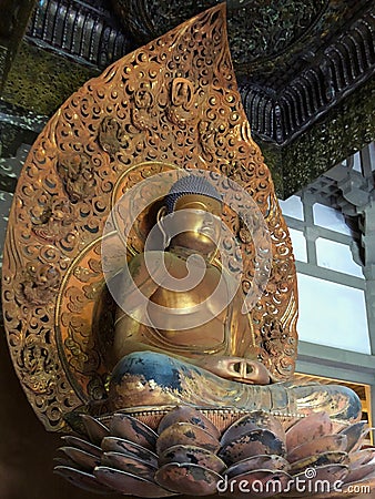 Golden statue of Buddha sitting on lotus in Byodo-in Temple in Oahu, Hawaii Stock Photo