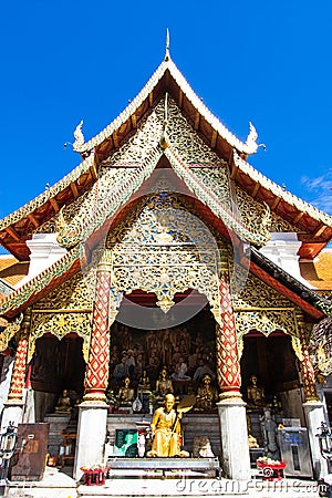 Golden statue of a monk place at the temple facade Editorial Stock Photo