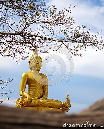 Golden statue of a sitting buddha, flanked by two Naga serpents in Thailand. Editorial Stock Photo