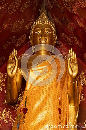 Golden statue of a standing Buddha in Wat Xieng Thong temple in Luang Prabang, Laos Stock Photo