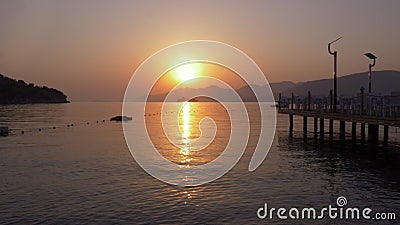 Golden sun and cruise ship floating on mountain silhouette while morning sunrise. Beautiful view bright sunset over sea. And mountain. Tourist liner shipping on stock footage Golden sun and cruise ship floating on mountain silhouette while morning sunrise. Beautiful view bright sunset over sea. And mountain. Tourist liner shipping on stock footage