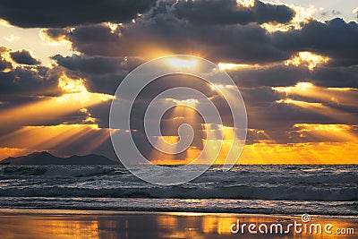 Golden sun rays on the sea at sunset Stock Photo