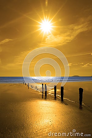 Golden sunrise over the beach and breakers Stock Photo