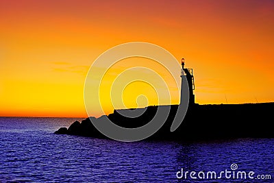 Golden sunrise sunset in sea red beacon lighthouse Stock Photo