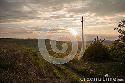 Golden sunset. Moldavian fields and hills. Spring or summer sunny down landscape. Stock Photo