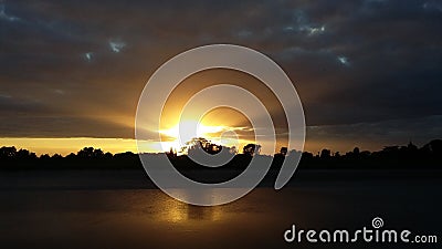 Golden Sunset Rays under Stratiform Clouds Stock Photo