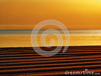 Golden sunset or sunrise on racked beach panorama. Stock Photo