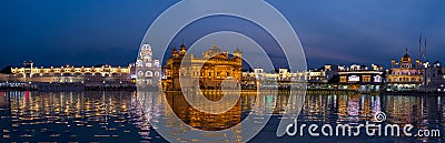 The Golden Temple at Amritsar, Punjab, India, the most sacred icon and worship place of Sikh religion. Illuminated in the night, r Stock Photo