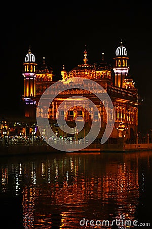 The Golden Temple at Amritsar, Punjab, India, the most sacred icon and worship place of Sikh religion. Illuminated in the night, . Stock Photo