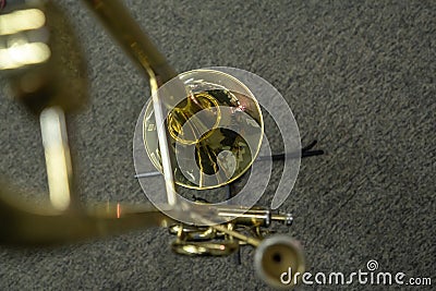 golden trombone on stand on carpet floor. top view. Stock Photo