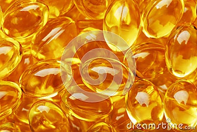 Golden Vitamin D3 Capsules close-up in full screen Stock Photo