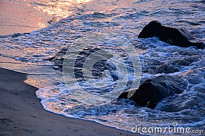 Golden Waves Along the Jetty at Sunrise Stock Photo