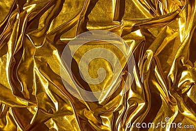 Golden wavy abstract background from a luxurious fabric, wavy folds, in the center a place for your gift in the form of Stock Photo