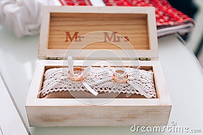 Golden wedding rings in a white wooden box. Wedding decoration. Symbol of family, unity and love Stock Photo