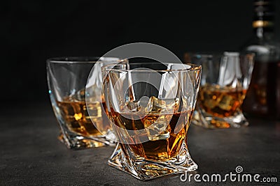 Golden whiskey in glasses with ice cubes Stock Photo
