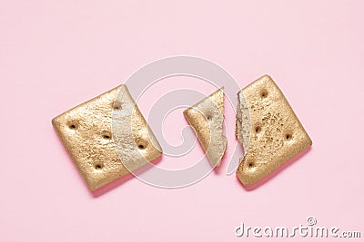 Golden whole and cracked cookies on light pink background, flat lay Stock Photo