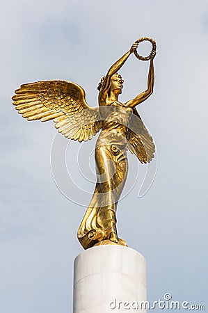 Golden winged goddess woman holding wreath is a top part of the monument Fallen Heroes of Macedonia, located in the Zena Borec Editorial Stock Photo