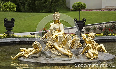Golden Woman and children statue at Linderhof Palace garden in Bavaria, Germany Stock Photo
