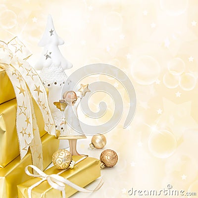 Golden wrapped christmas presents with an angel on wooden background. Stock Photo