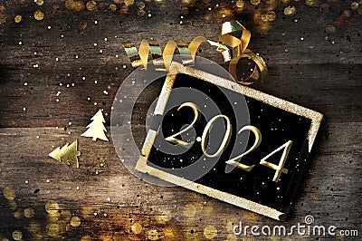 golden 2024 written on little board on rustic wooden Stock Photo